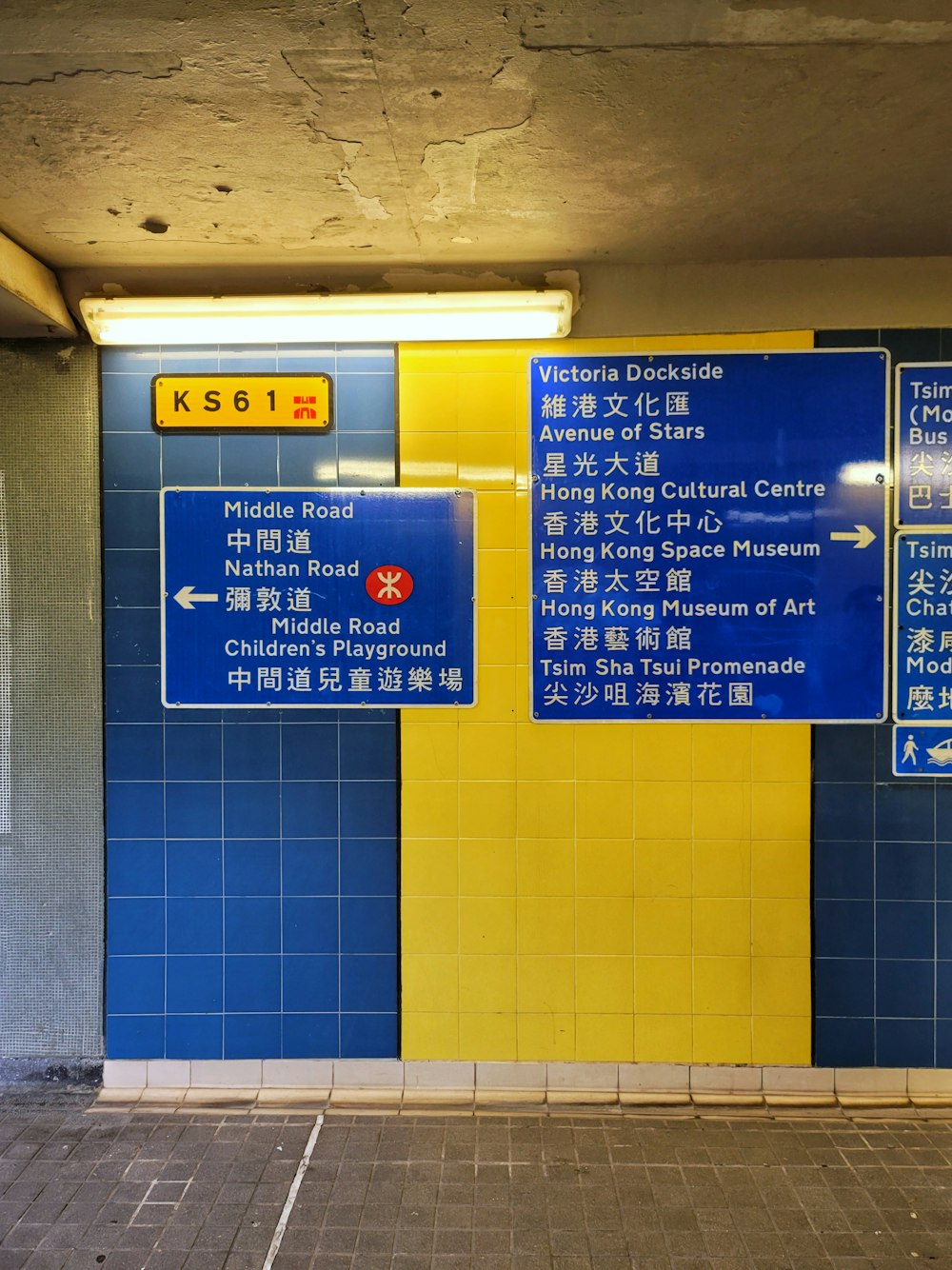 a blue and yellow wall with a bunch of signs on it