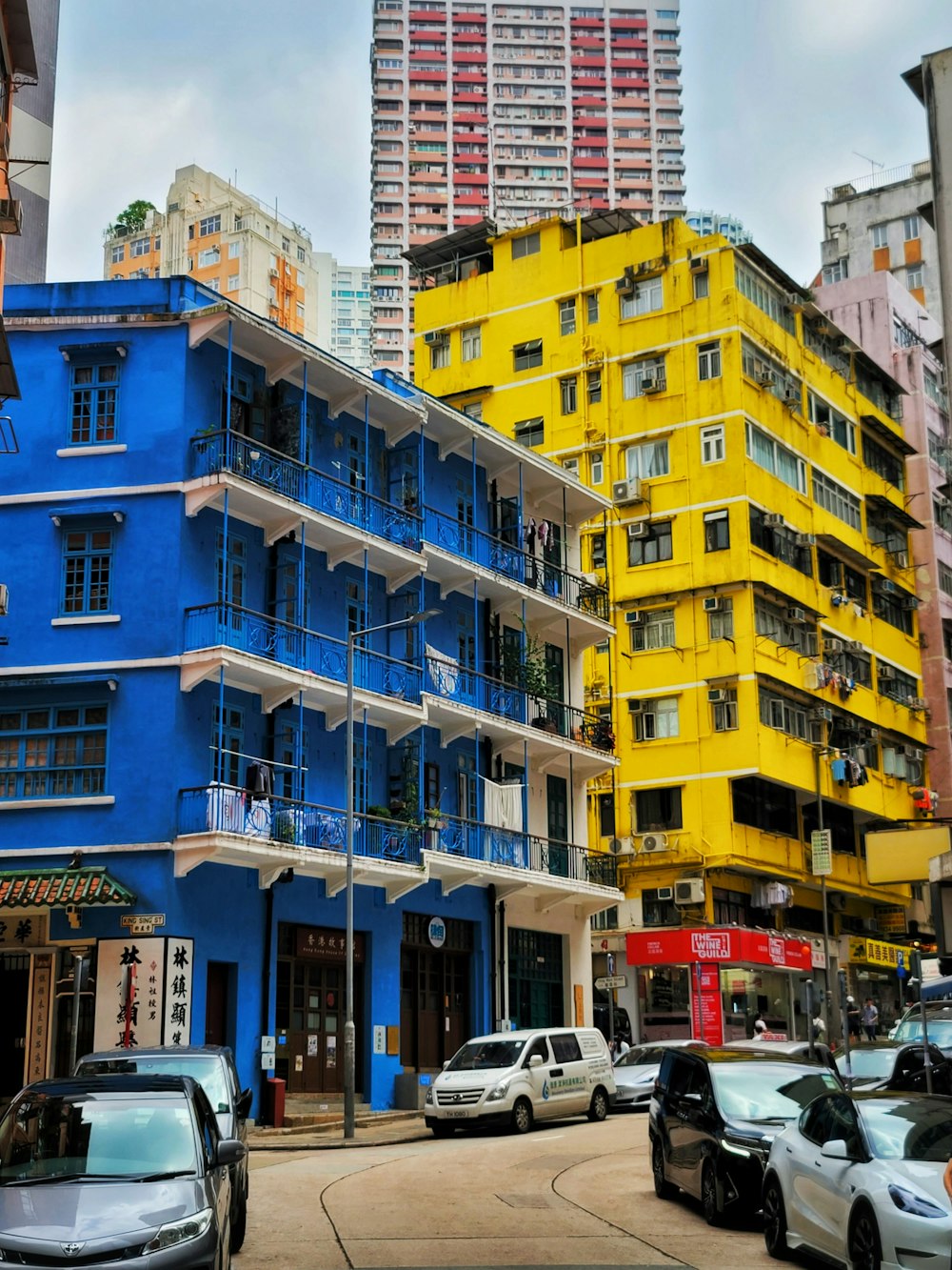 a blue and yellow building with cars parked in front of it