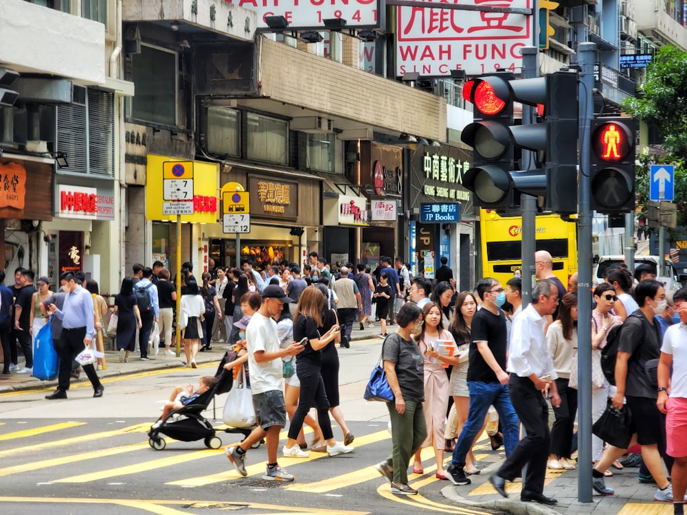 a group of people crossing a street at a crosswalk