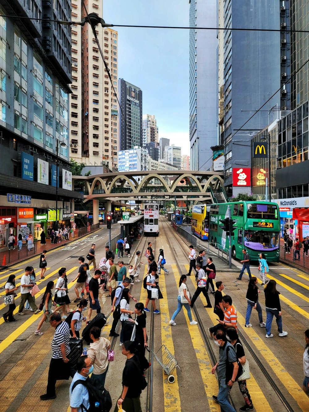 a group of people crossing a street in a city