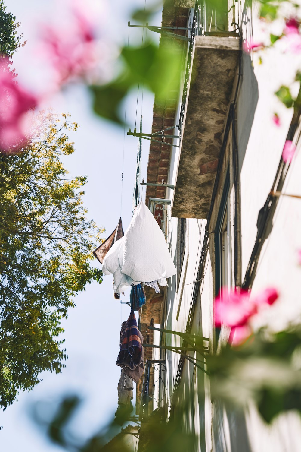 a person hanging an umbrella from a building