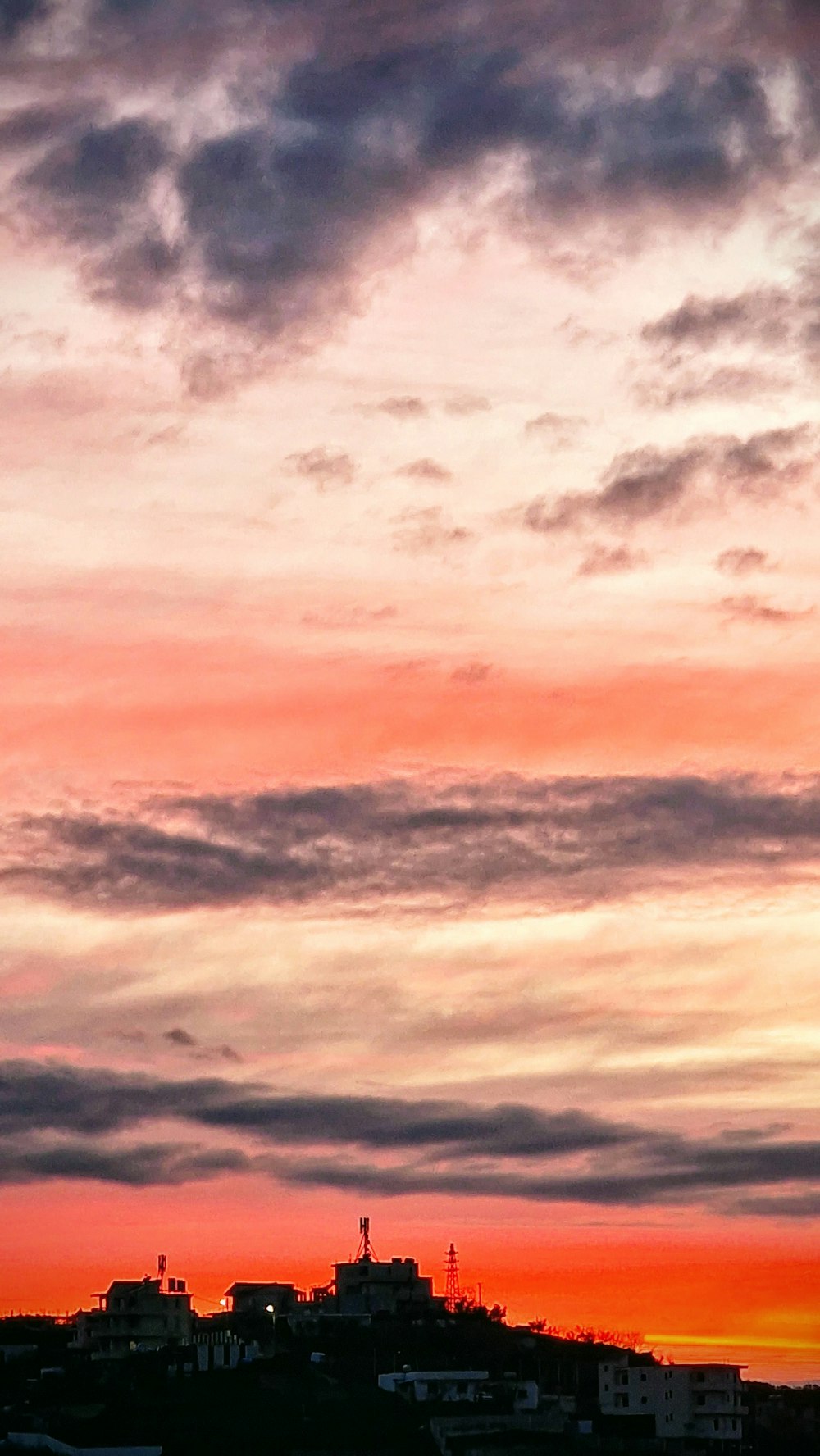 a plane is flying in the sky at sunset