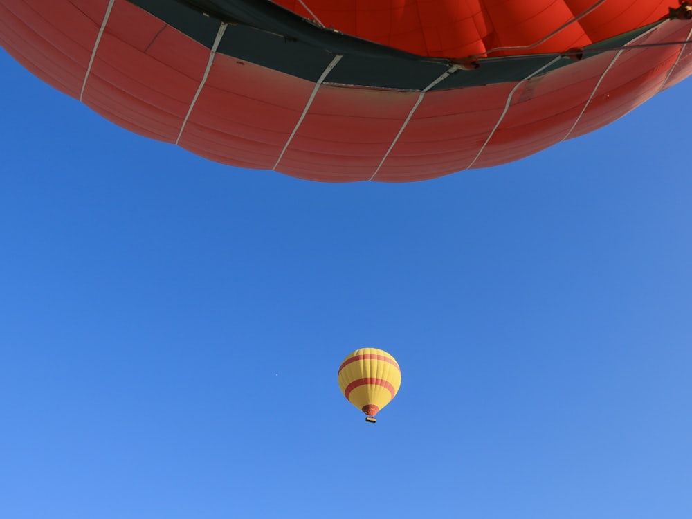 a hot air balloon flying through a blue sky