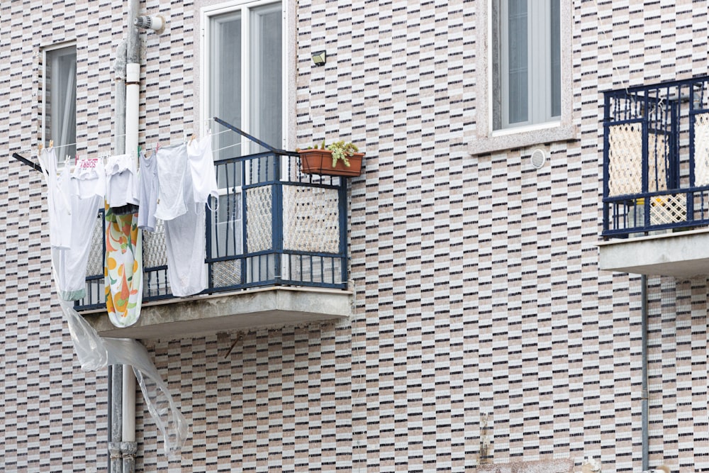 a balcony with clothes hanging out to dry