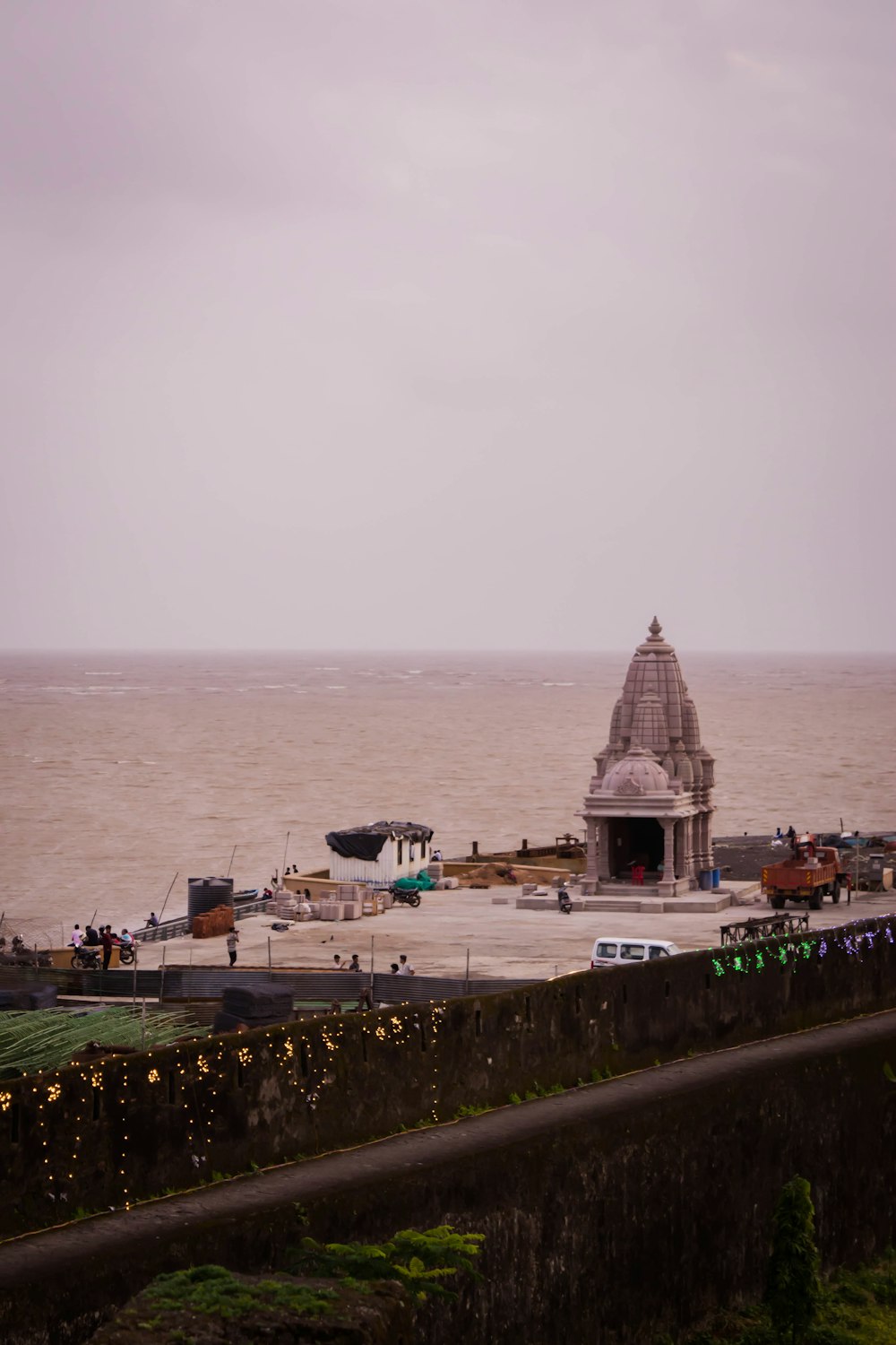 a large body of water with a small building in the middle of it