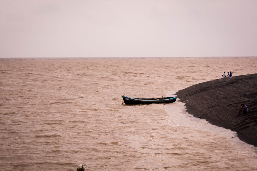 a boat sitting on top of a large body of water