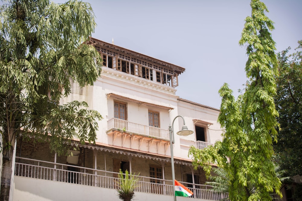 a large white building with a flag on top of it