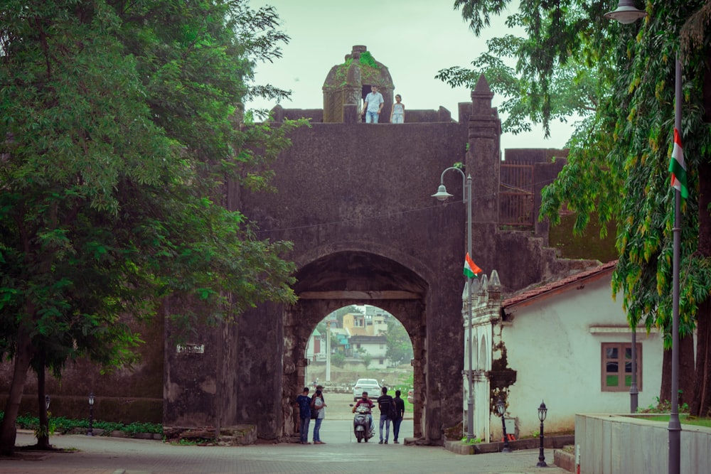 a group of people standing in front of a gate