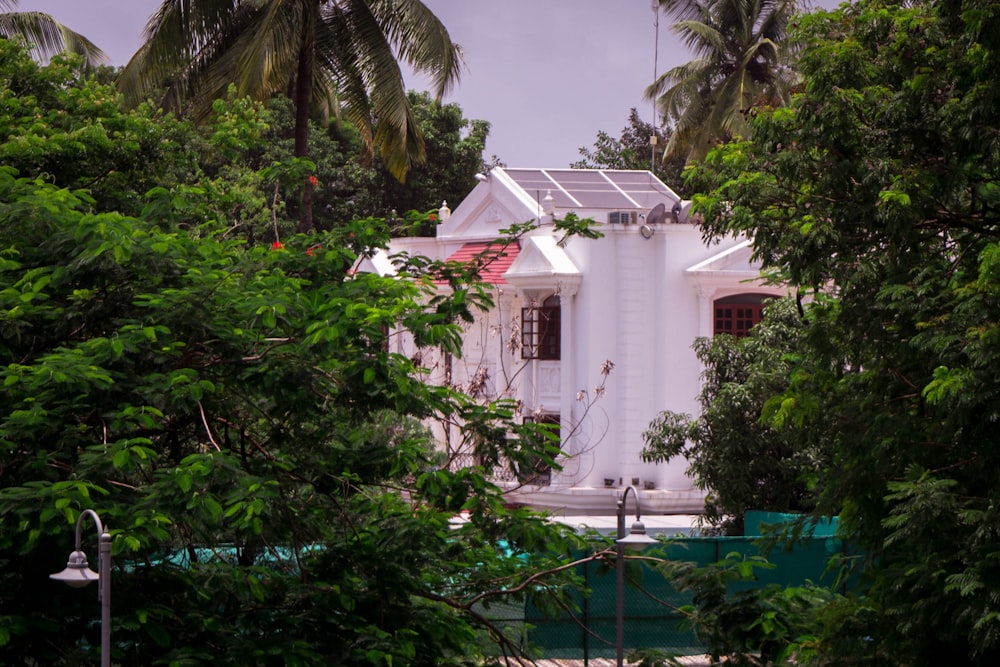 a white house with a solar panel on the roof