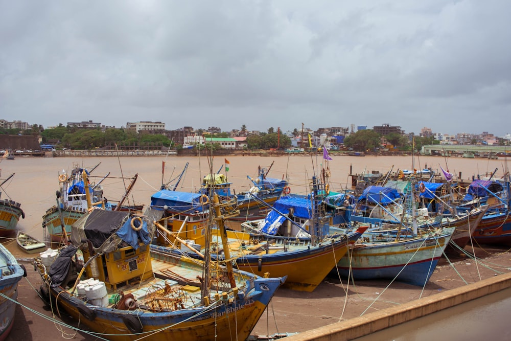 a group of boats that are sitting in the sand