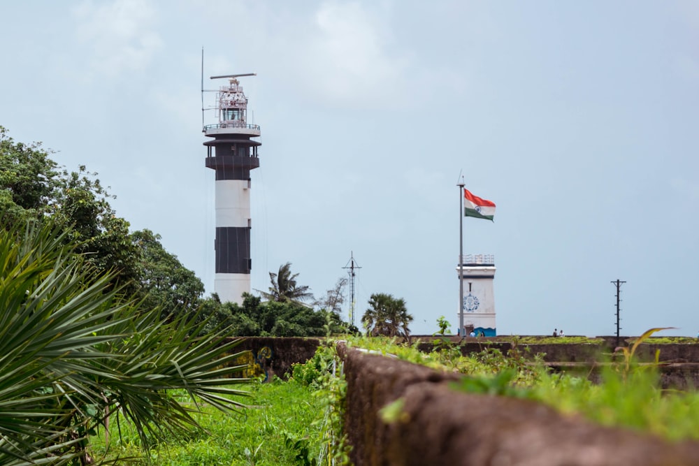 a lighthouse with a flag on top of it