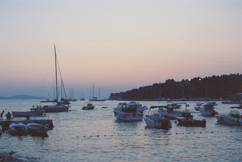 a group of boats floating on top of a body of water