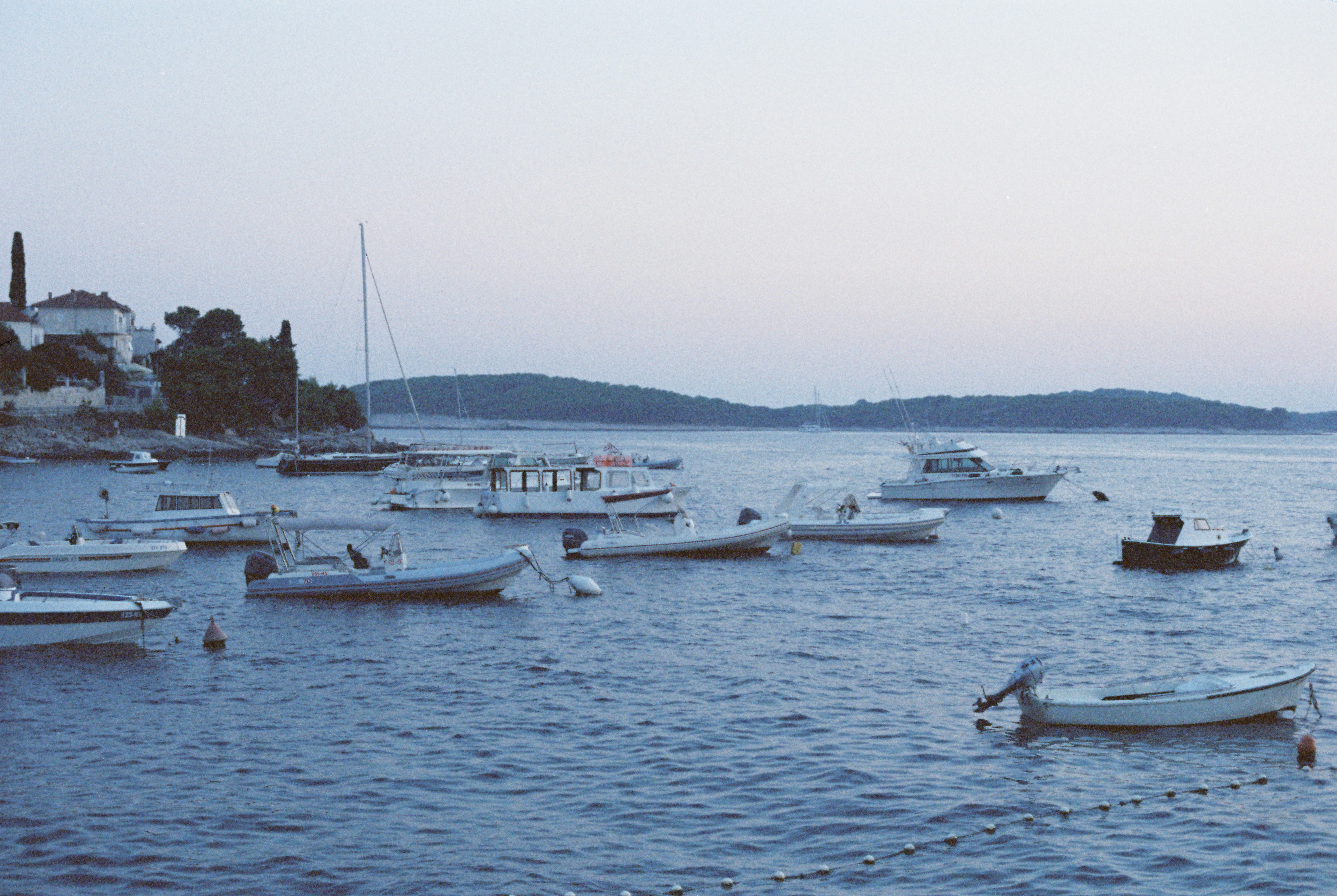 a group of boats floating on top of a body of water, 