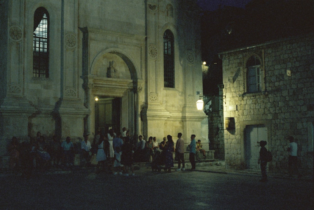 a group of people standing in front of a building