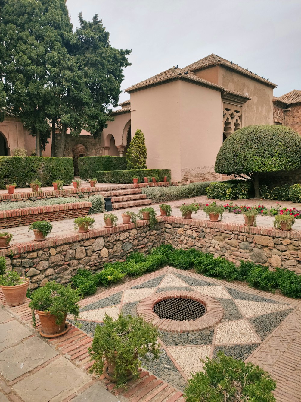 a garden with a fire pit in the middle of it