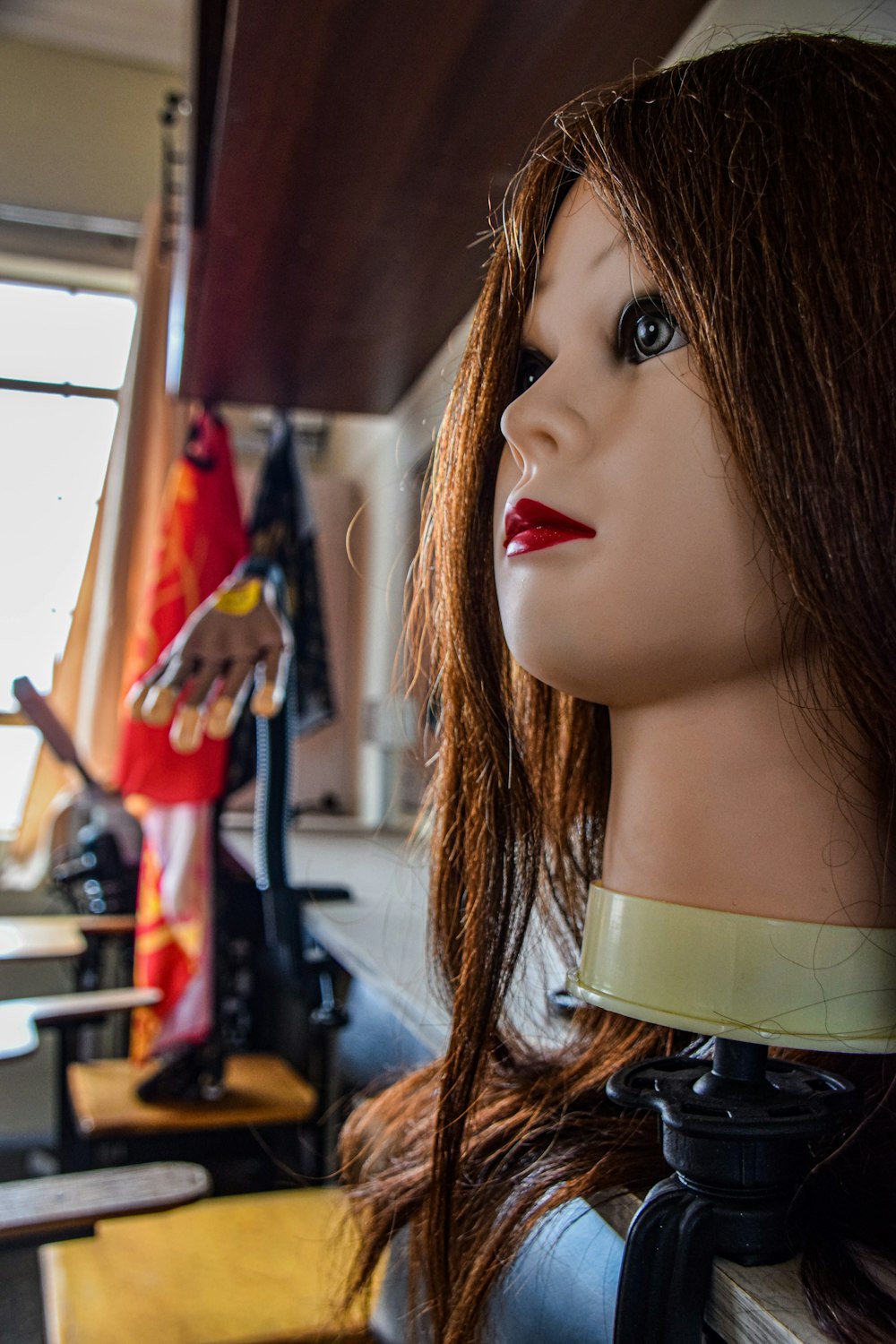 a close up of a mannequin's head on a shelf