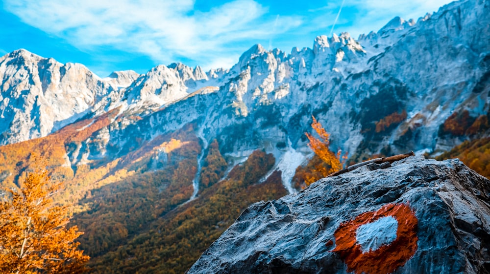 a rocky outcropping with mountains in the background