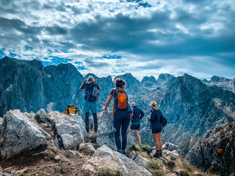 a group of people standing on top of a mountain