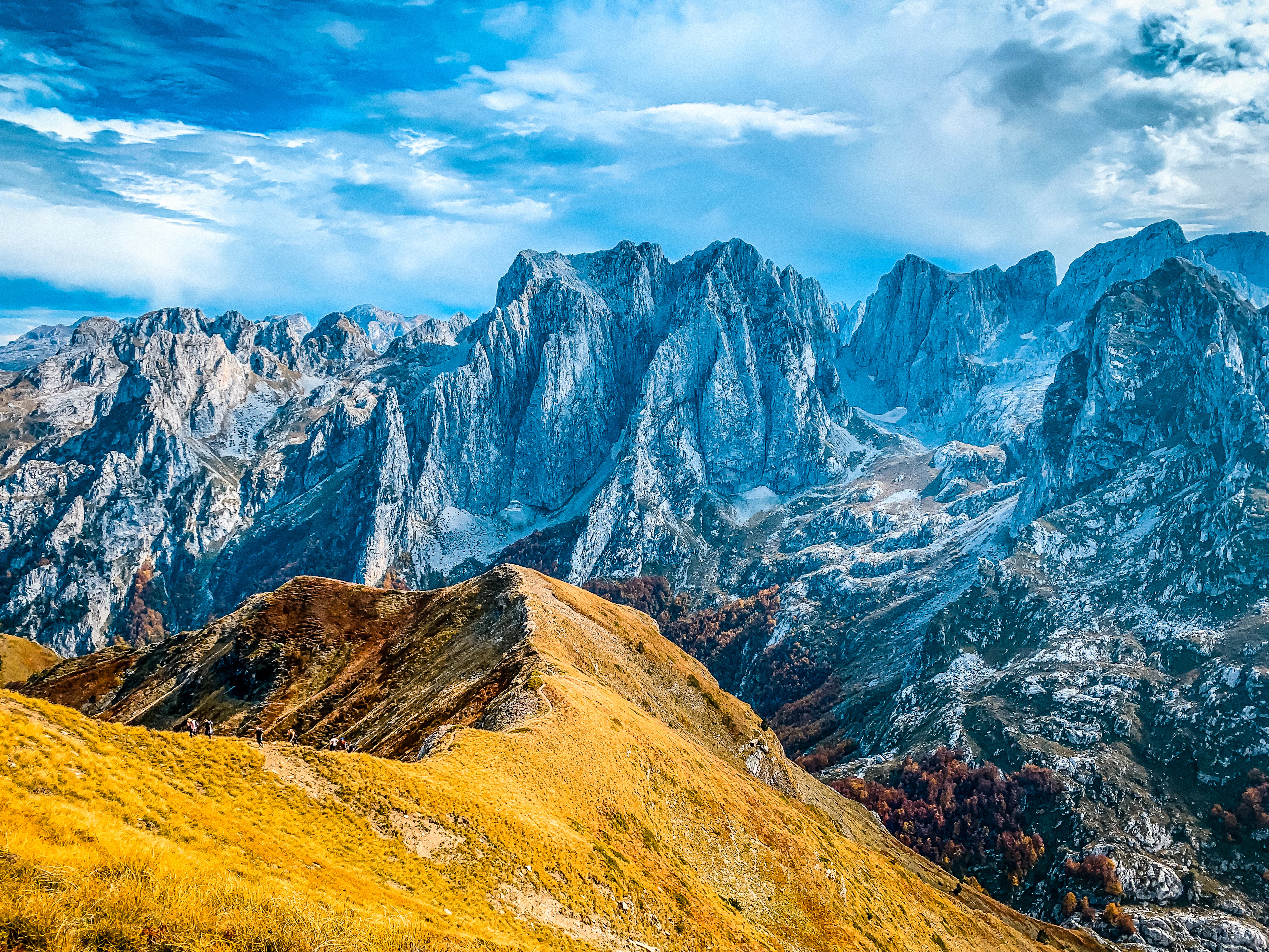 An autumn-coloured grassy ridge and sharp limestone peaks above the Grbaja valley, Montenegro