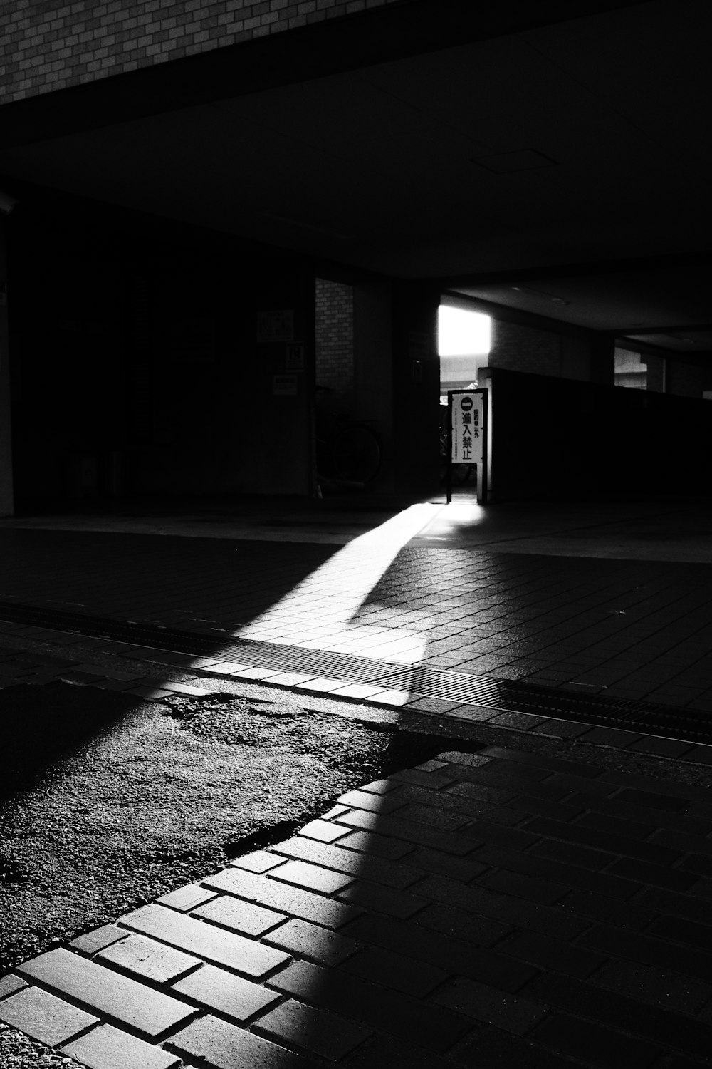 a black and white photo of a sidewalk