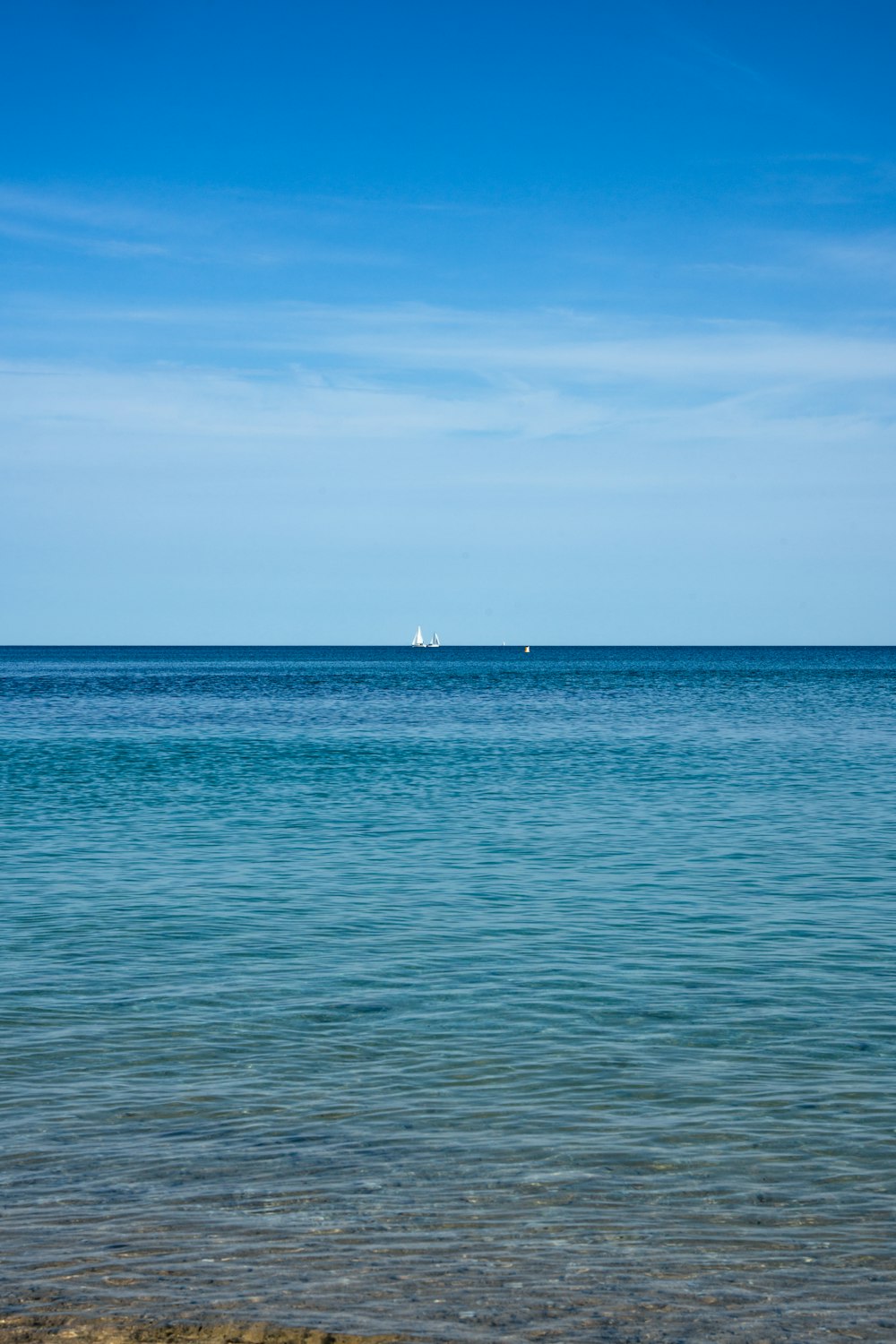 a body of water with a boat in the distance