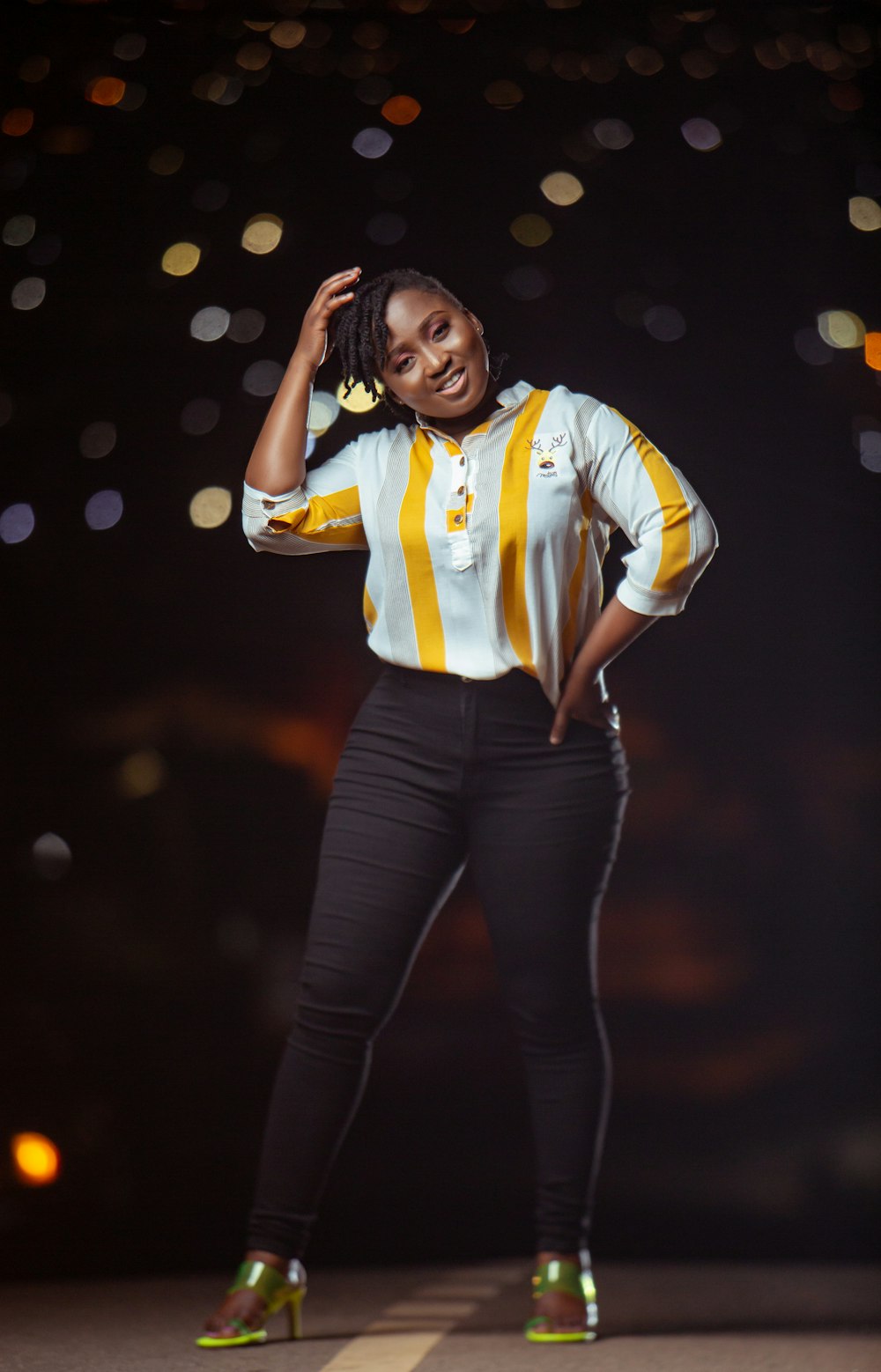 a woman in a yellow and white striped shirt