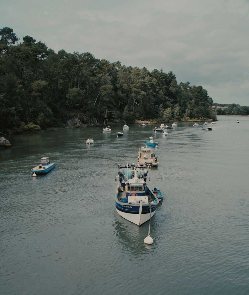 a group of boats floating on top of a river