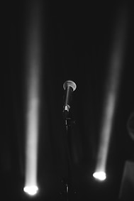 a black and white photo of a microphone and lights