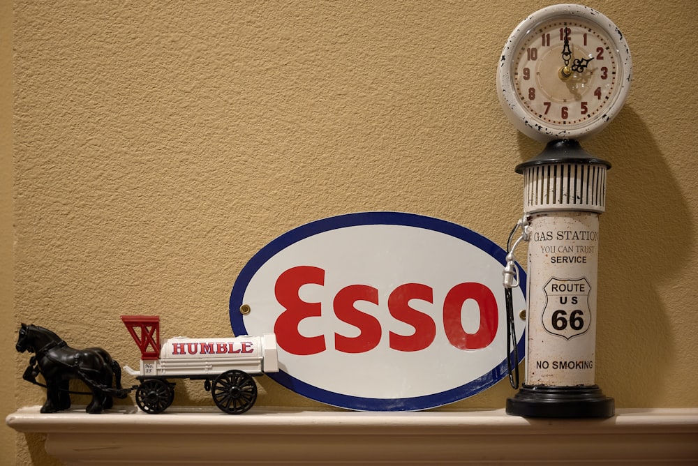 a gas pump and a clock on a mantle