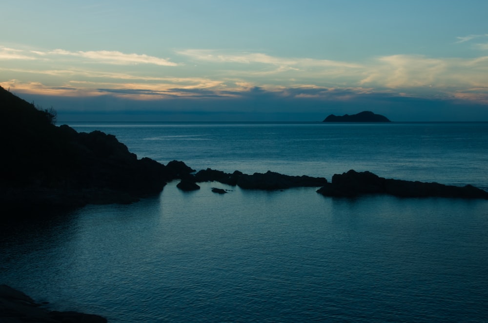 a body of water with a small island in the distance