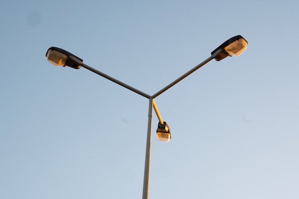 a couple of street lights sitting on top of a pole