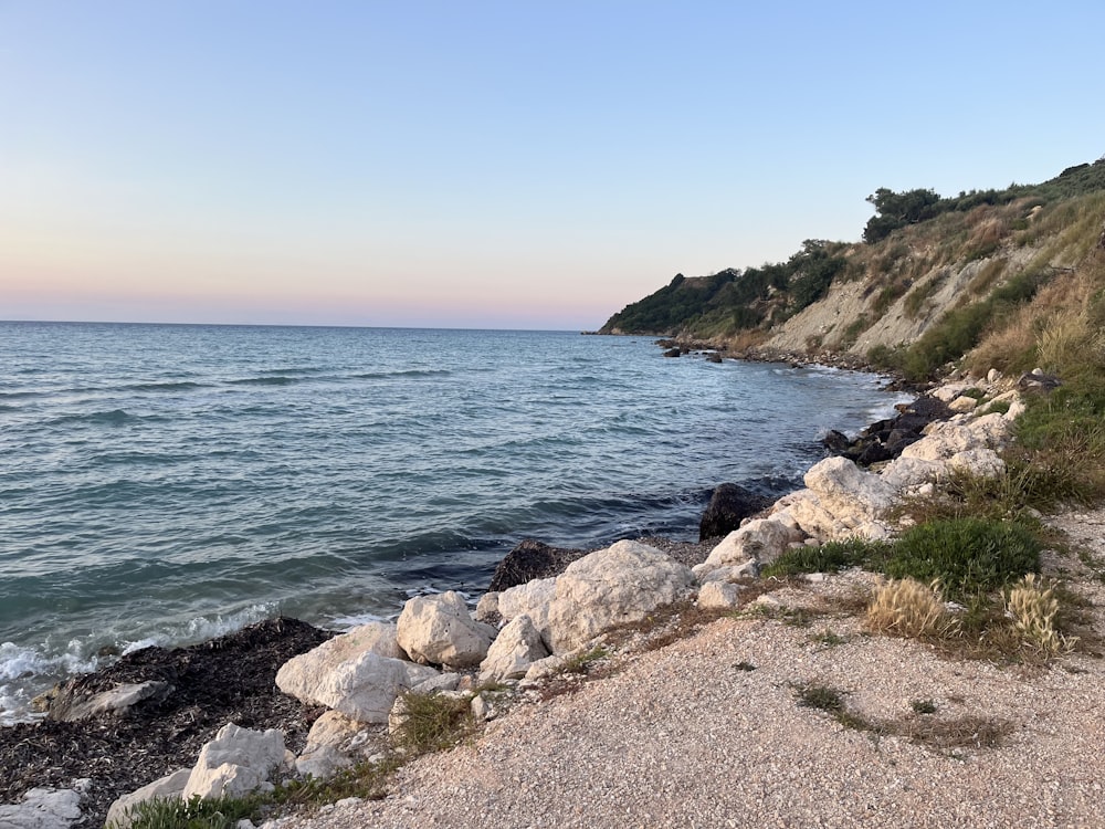 a view of the ocean from a rocky shore