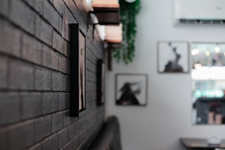 a brick wall in a restaurant with pictures on the wall