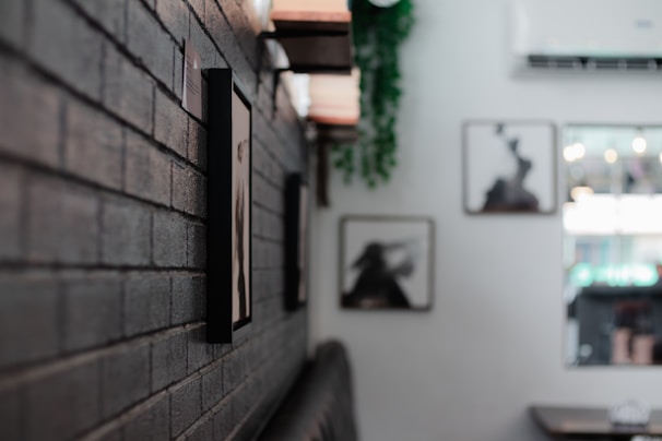 a brick wall in a restaurant with pictures on the wall