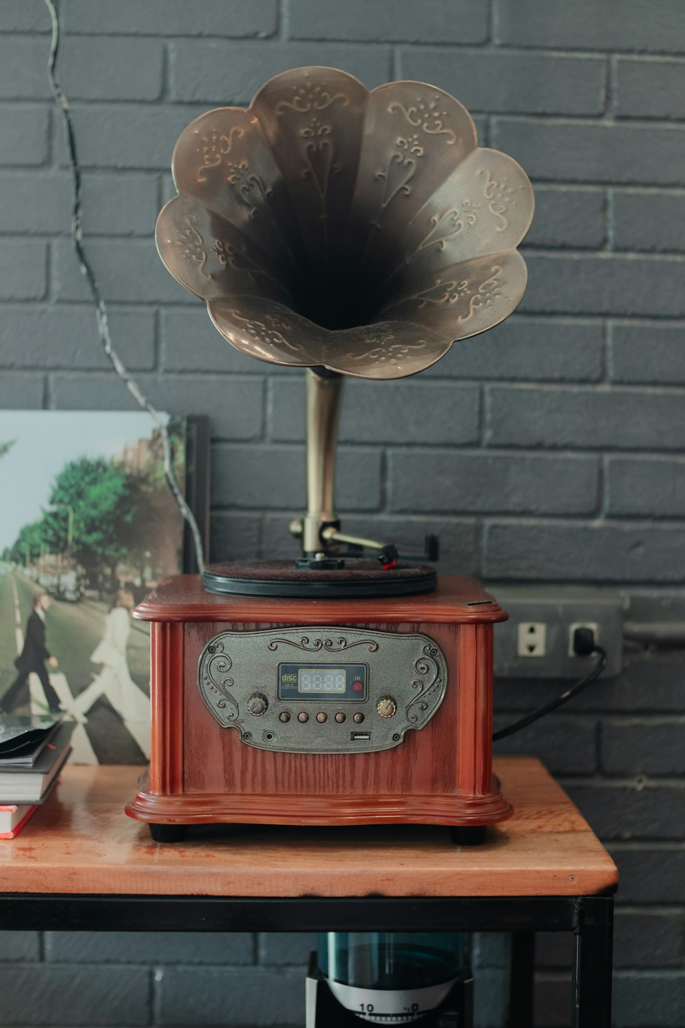 a wooden table topped with a radio and an old fashioned record player