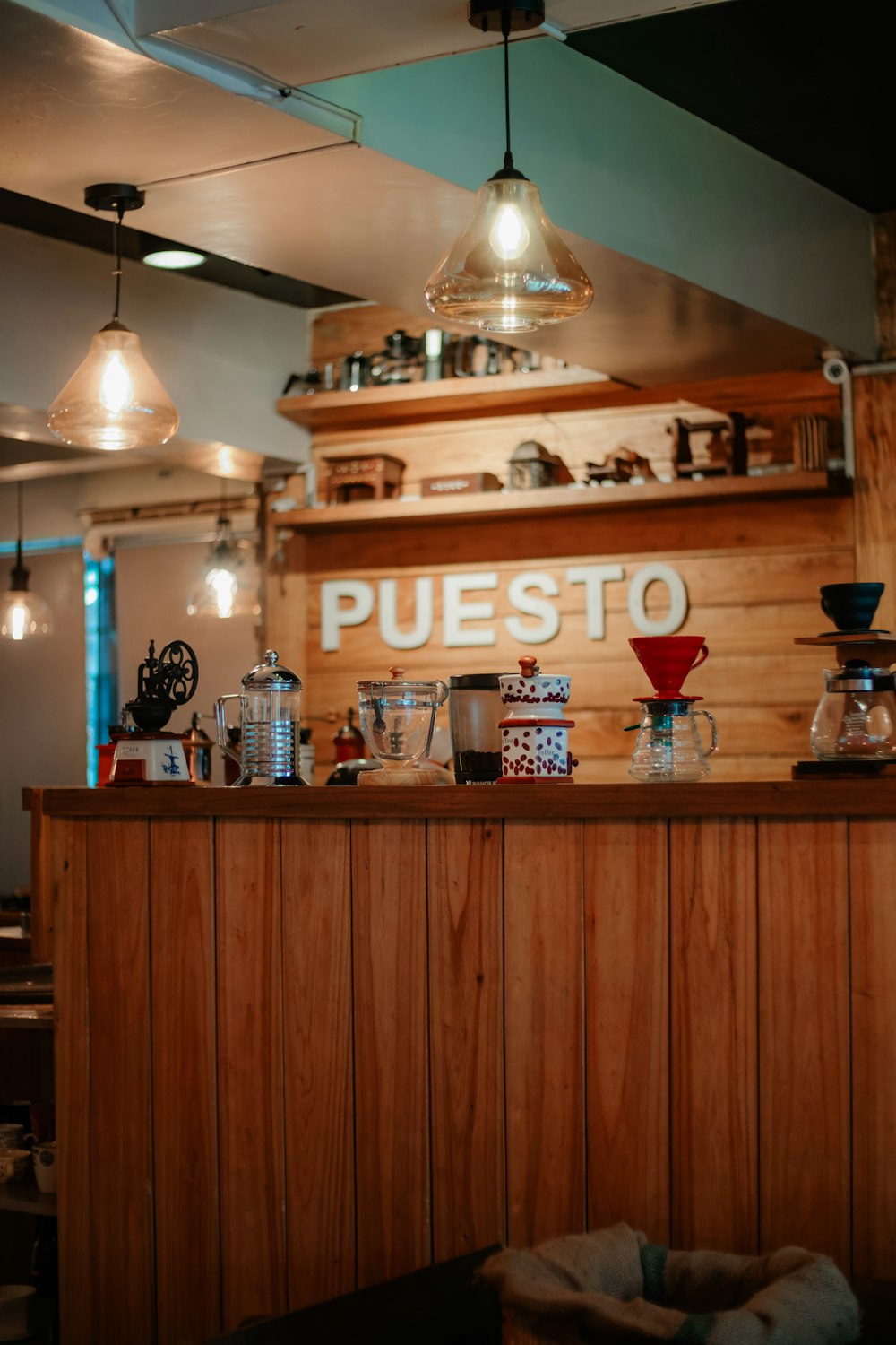 a wooden counter with a bunch of cups on top of it