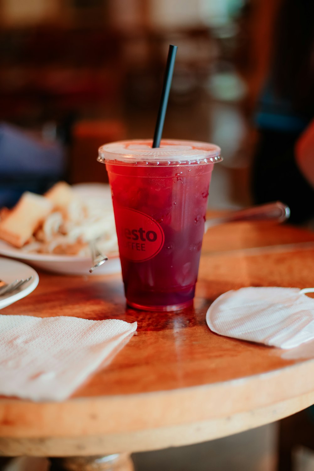 a plastic cup with a straw sitting on top of a table