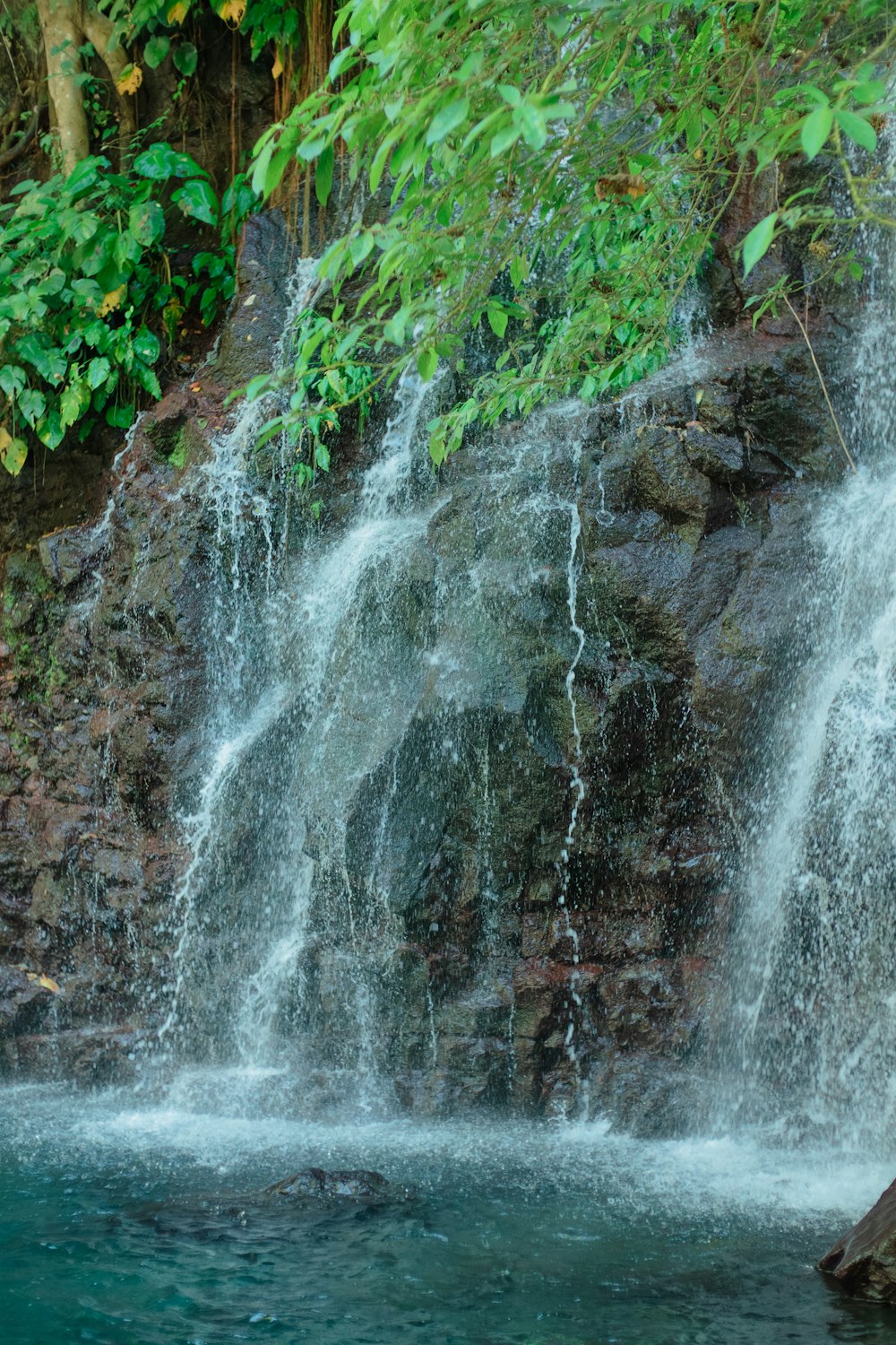 a man standing in front of a waterfall