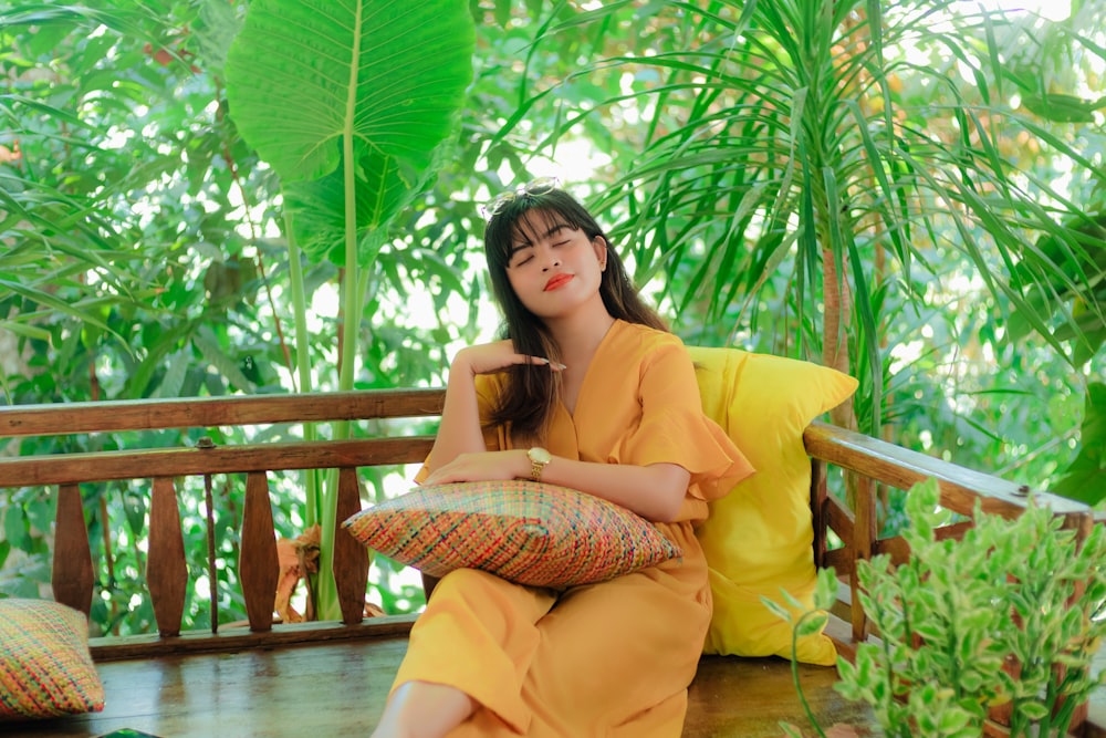 a woman in a yellow dress sitting on a porch