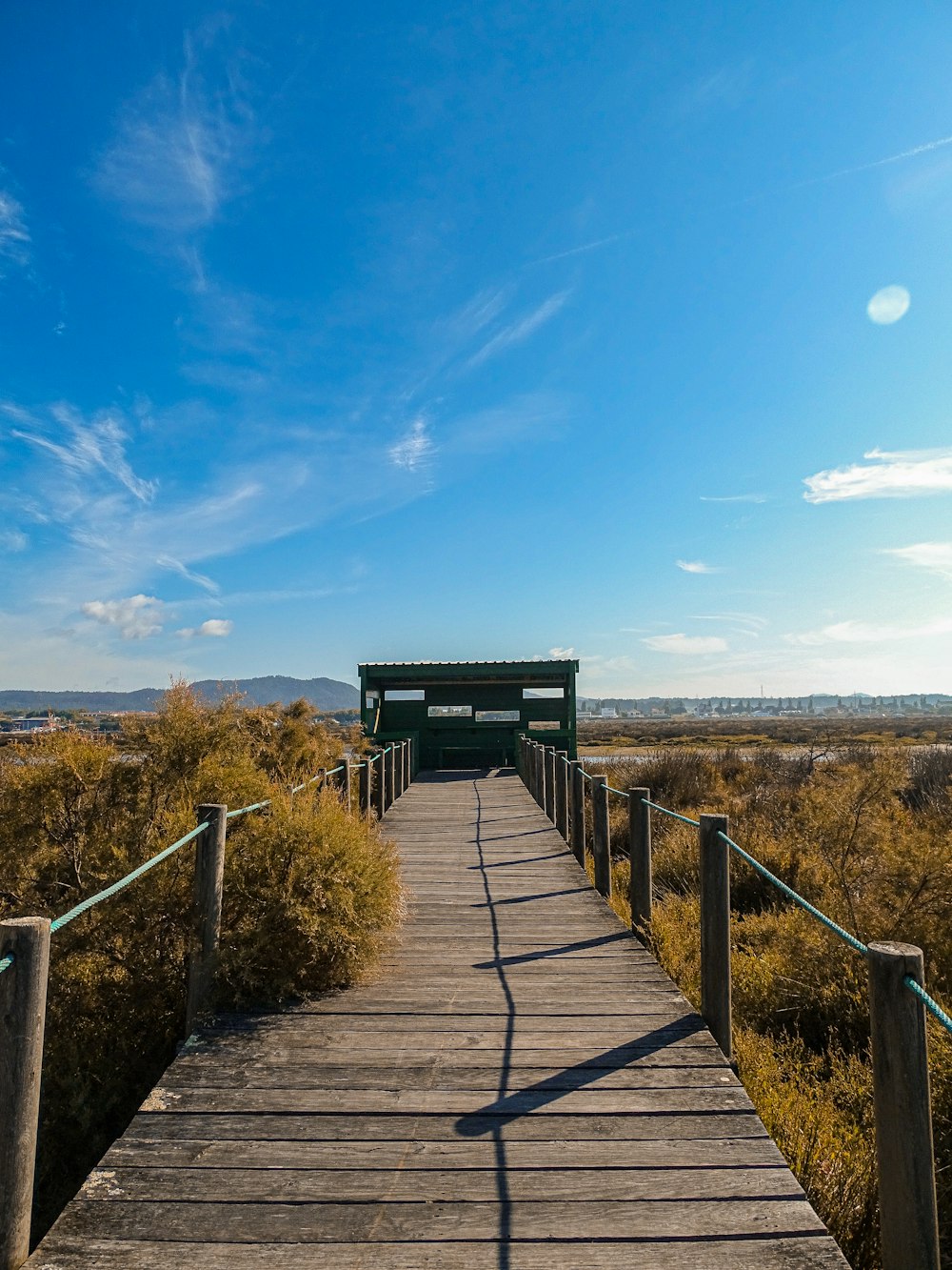 a wooden walkway with a bench on top of it