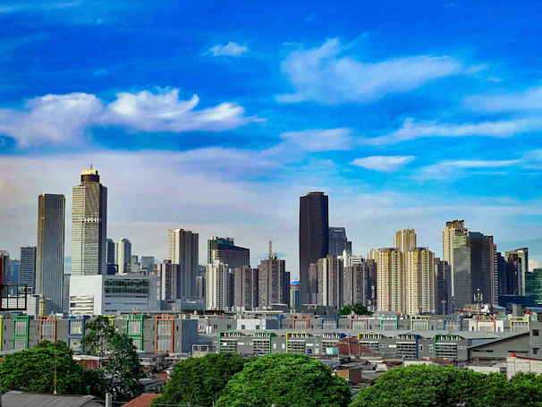 A modern UK city skyline with residential and commercial buildings under a clear sky.