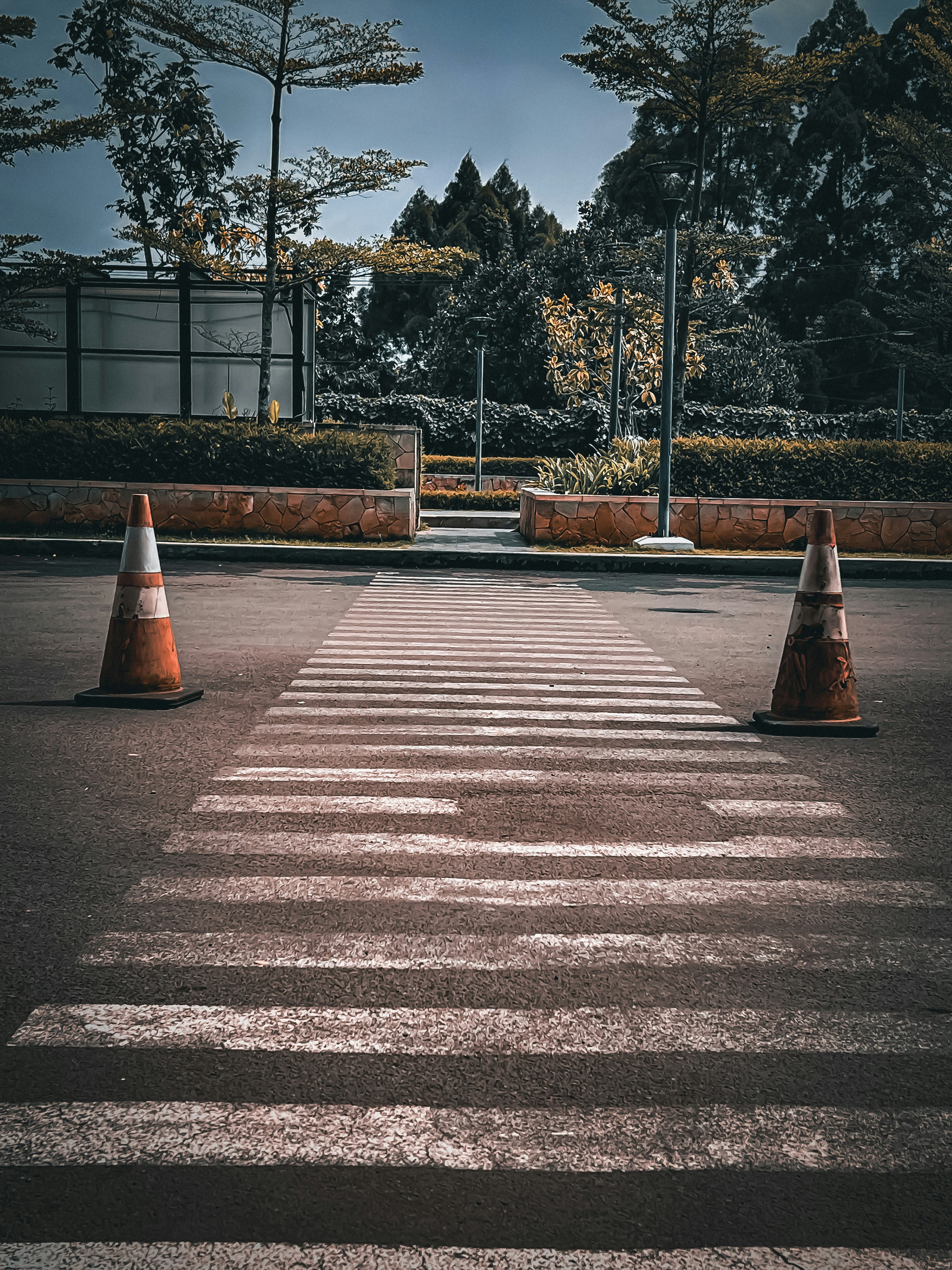 an empty parking lot with traffic cones in the middle of it