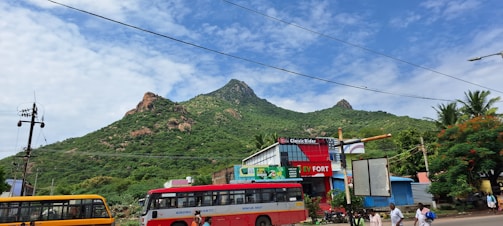 A scenic view of a city skyline with electric buses on the road.