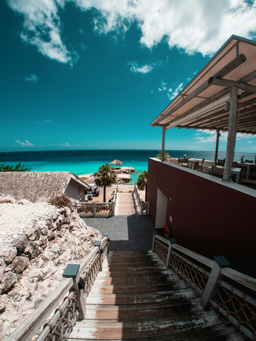 a stairway leading to a beach with a view of the ocean