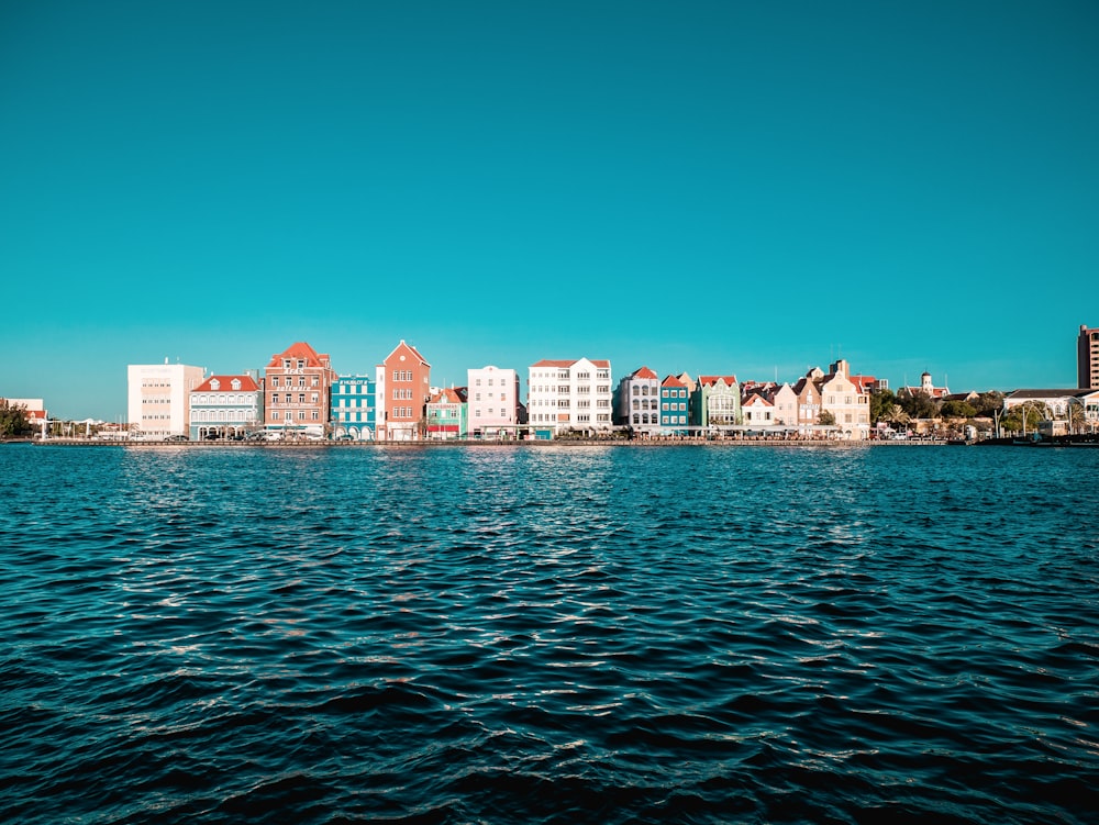 a body of water with buildings in the background