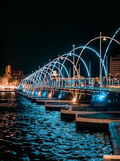 a long bridge over a body of water at night