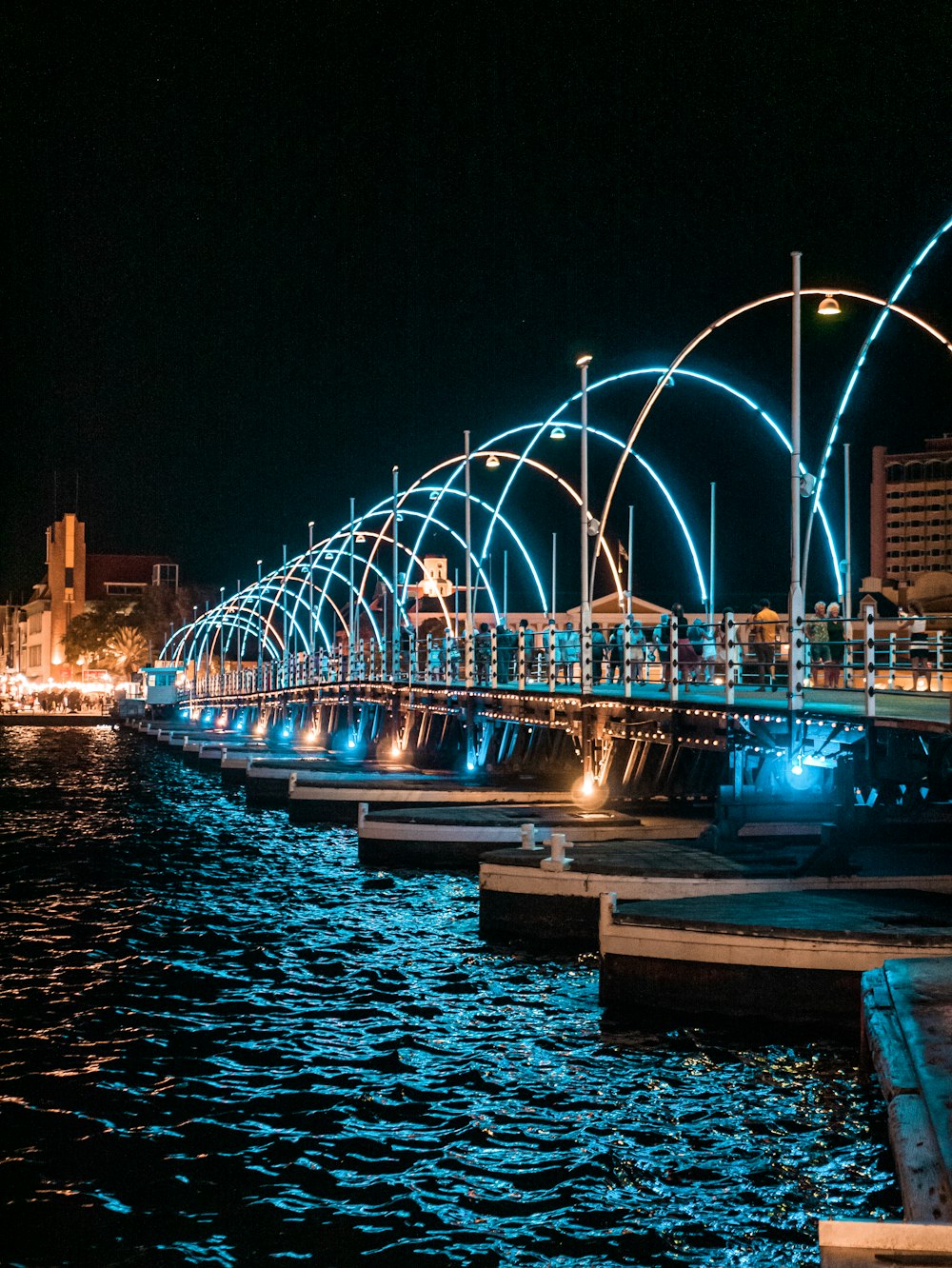 a long bridge over a body of water at night
