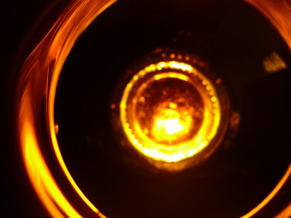 a close up of a yellow light in a dark room