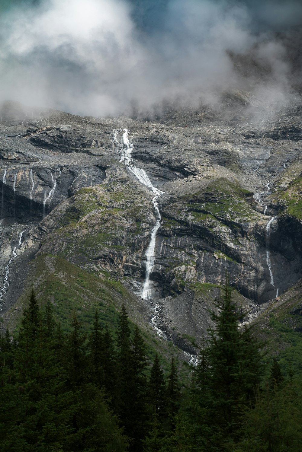 a view of a mountain with a waterfall coming out of it