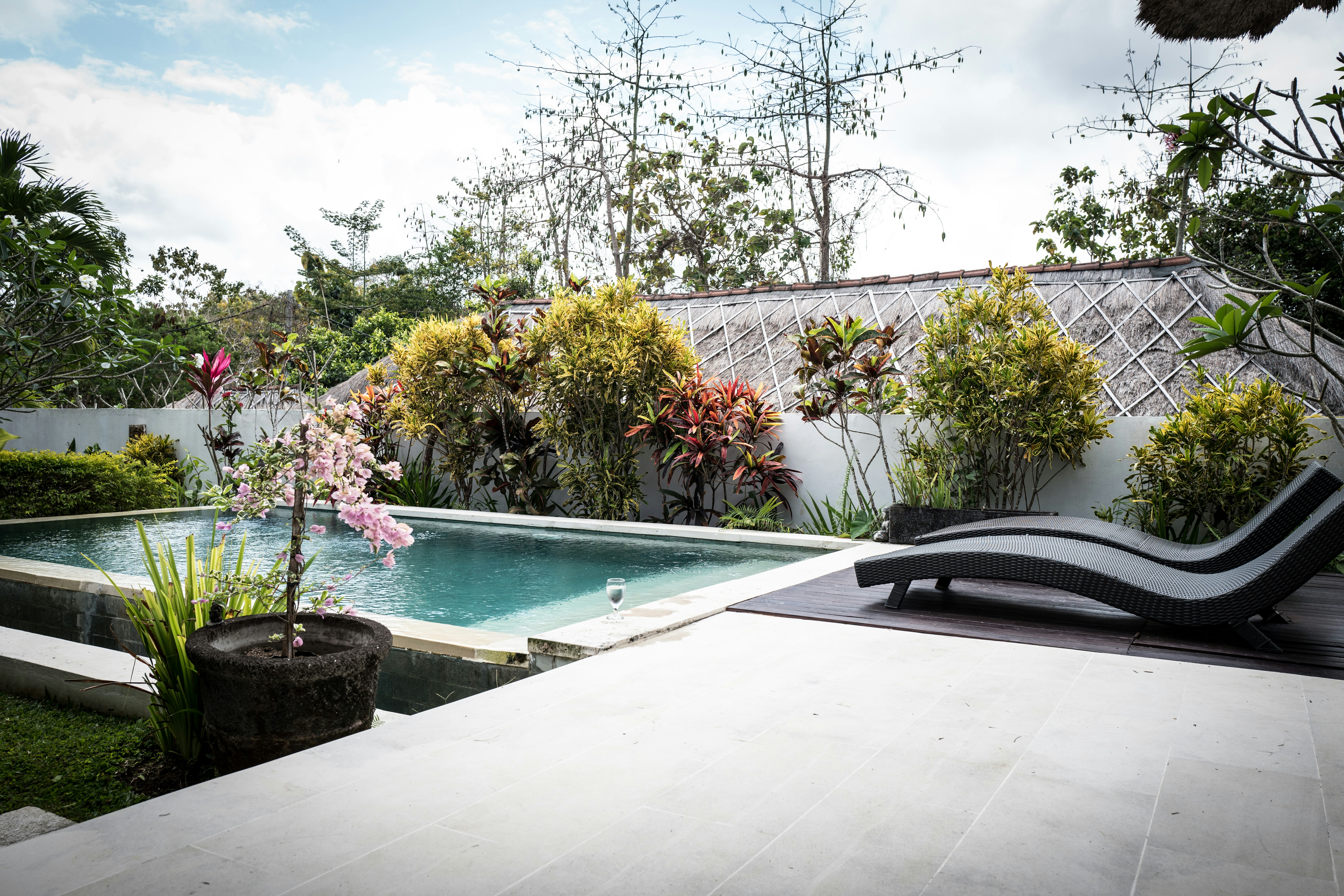 a pool with a lounge chair next to it
